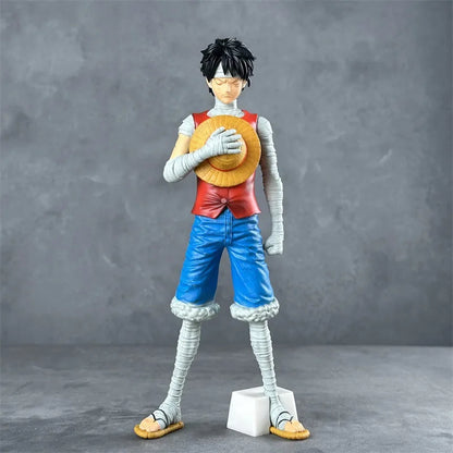 Figurine Monkey D. Luffy One Piece 30cm - Corps bande des bras aux jambes, chapeau de paille tenu contre la poitrine, fond gris